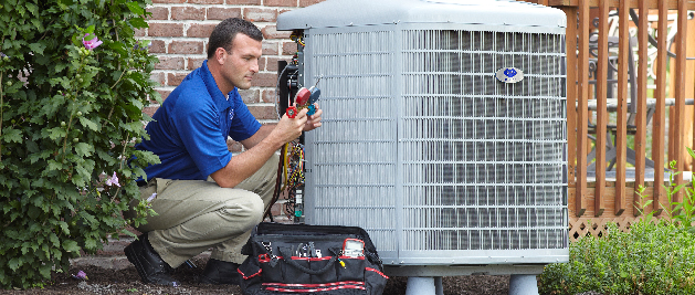 Service technician fixing A/C