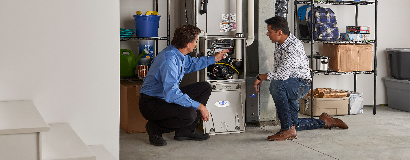 Technician educating homeowner following a furnace replacement 